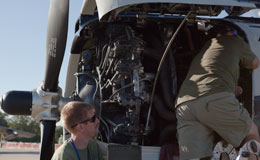 men working on plane engine